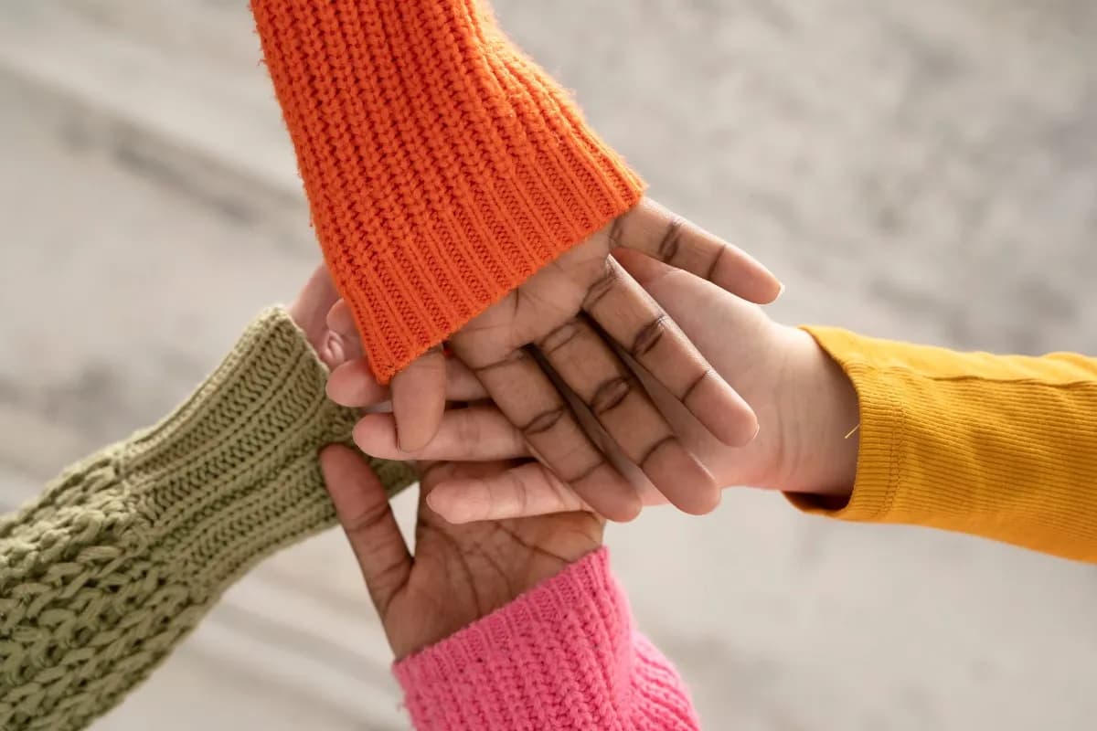 Hands coming together, symbolizing unity and support for impactful programs